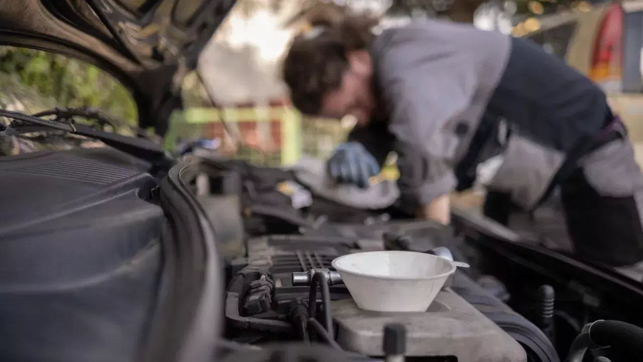 CAA worker doing an oil change