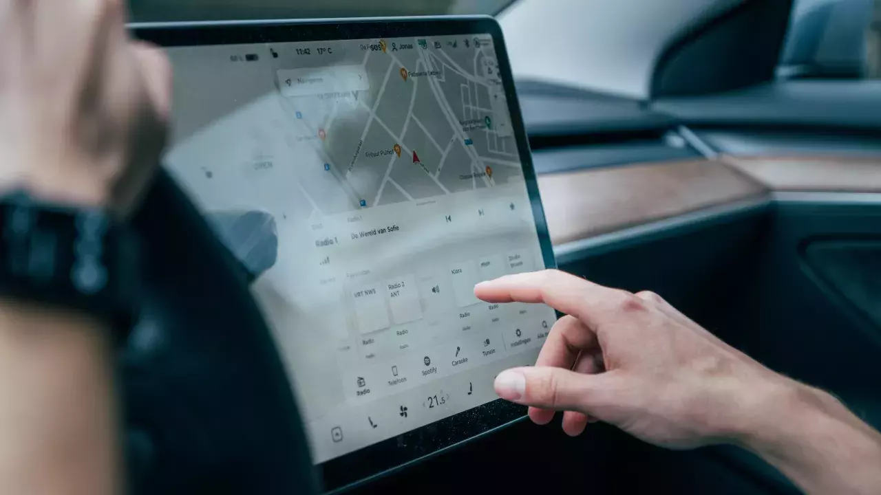 driver selecting options from tesla screen