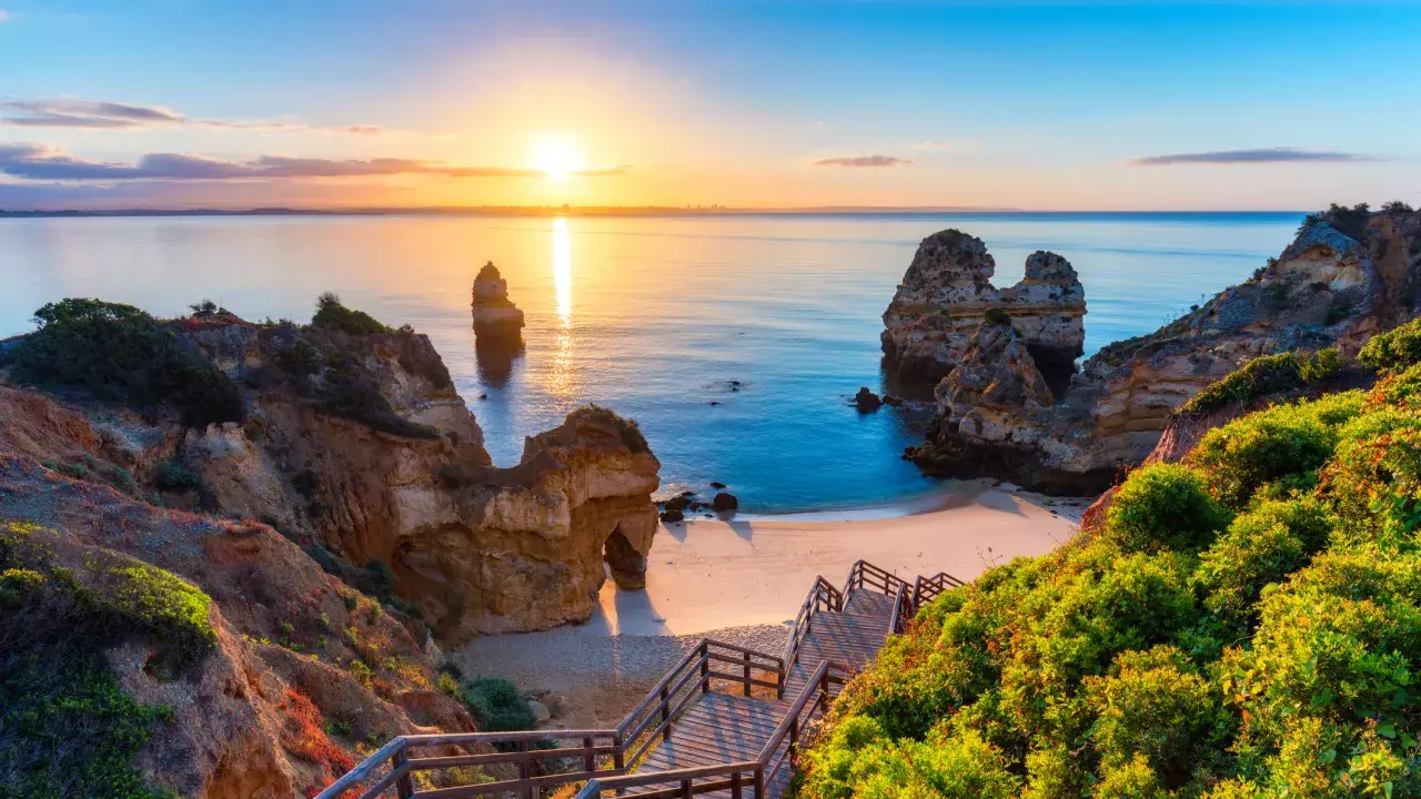 A staircase heading to the beach at sunset in the Algarve Coast, Portugal. 