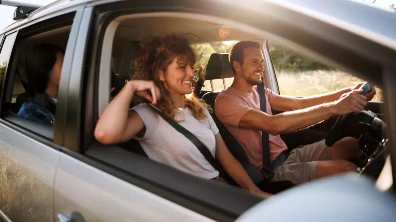 A young group of friends driving their car