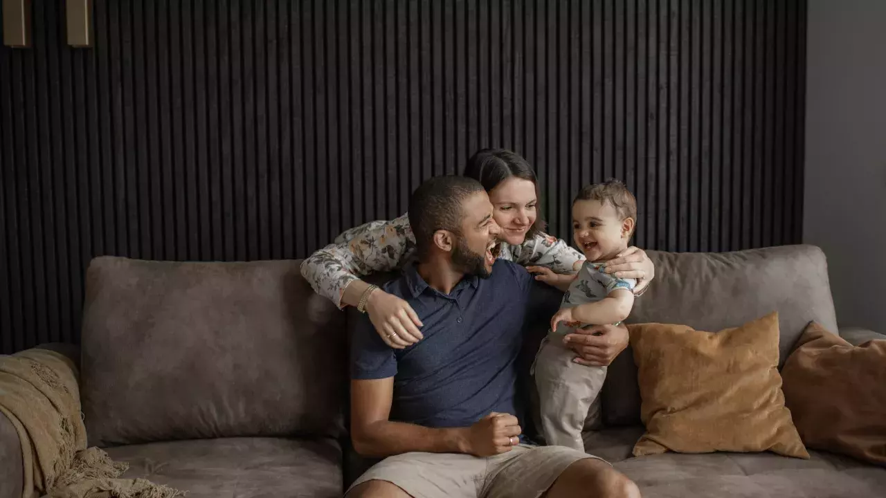 family at home sitting on sofa happy