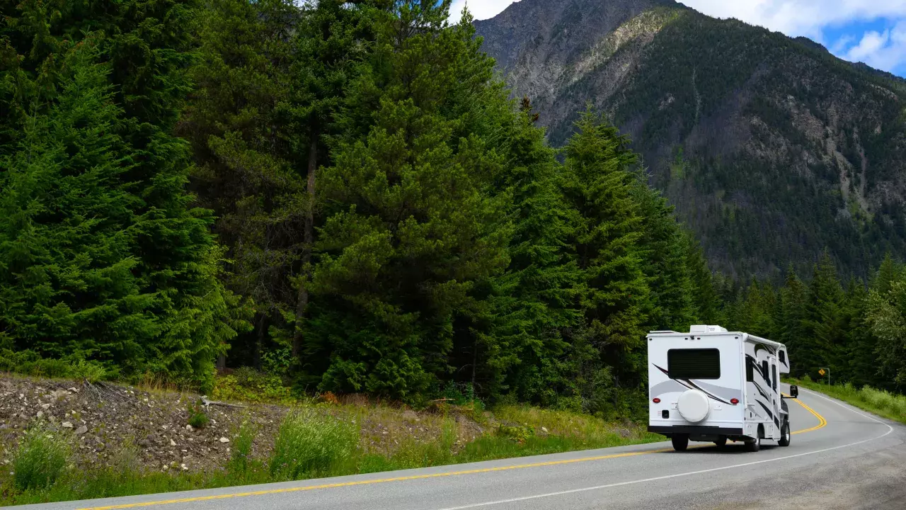 Motor home moving on road against mountain 