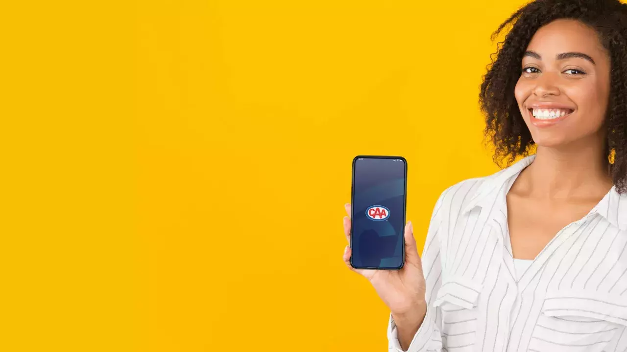 woman showing the caa app on her phone