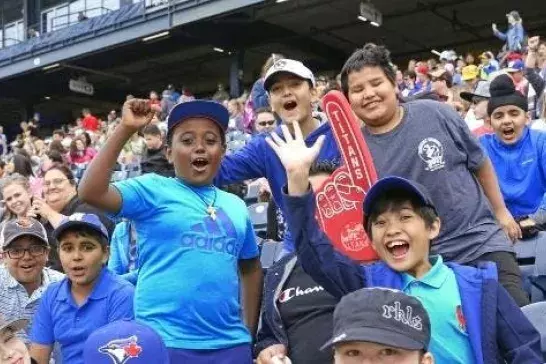 sport fans in a crowd smiling