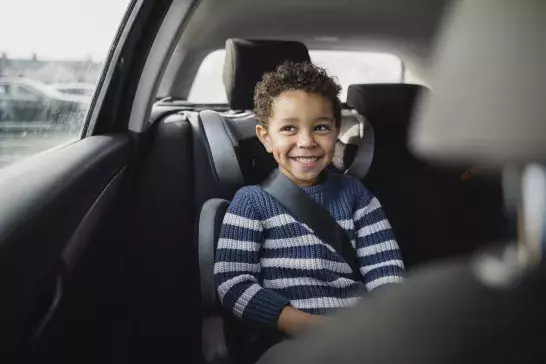 Child in child or baby seat in a car