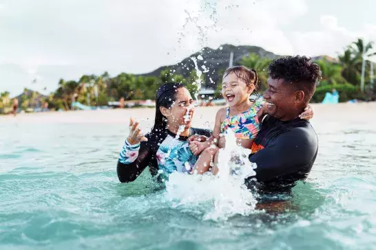 Family playing in the water on vacation