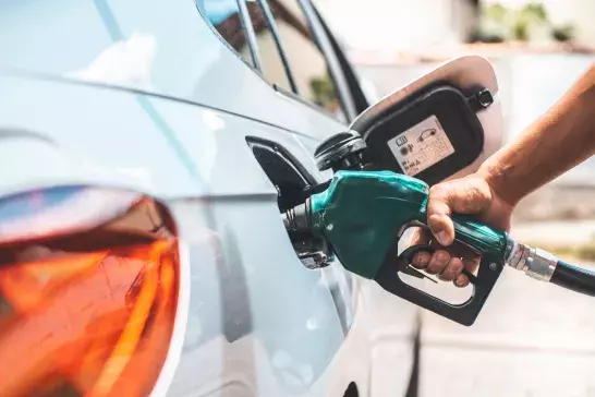 Person fueling up their car with gas