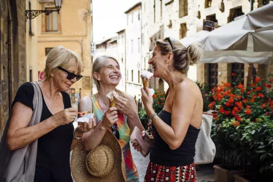 Women travellers eating gelato in Italy