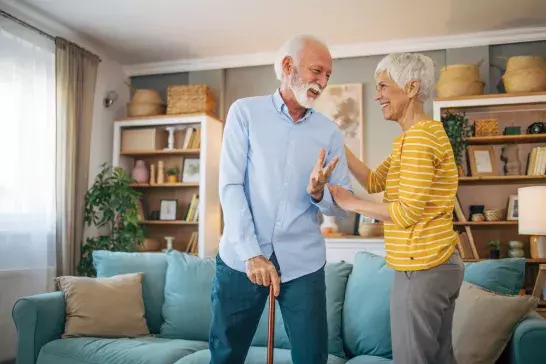 Senior couple standing in living room