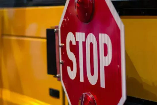 picture of the stop sign on the side of a school bus