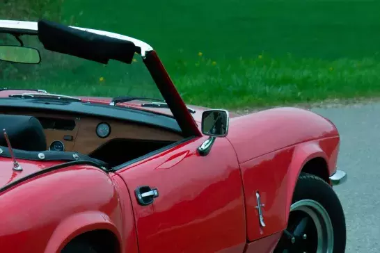 A red convertible stop on the road