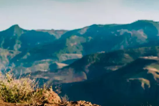 Happy boy and girl travel by car in mountains