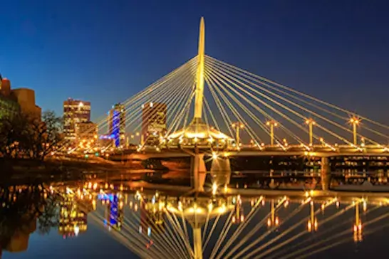 A picture of a bridge in Winnipeg, Manitoba lit up at night