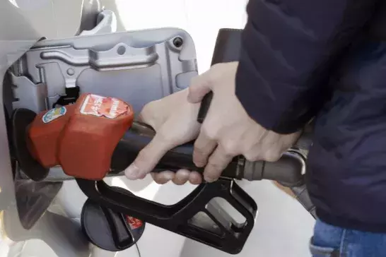 Person pumping fuel into their vehicle