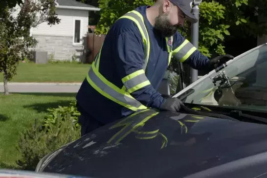 CAA technician at a Member's home fixing a windshield chip 