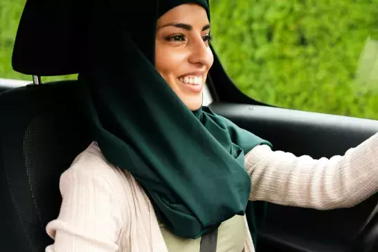 A muslim woman is driving car with her daughter