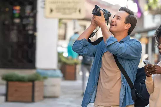 Couple walking and taking photos on vacation