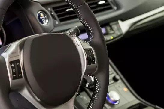 Leather interior of a vehicle with the lights and radio running.