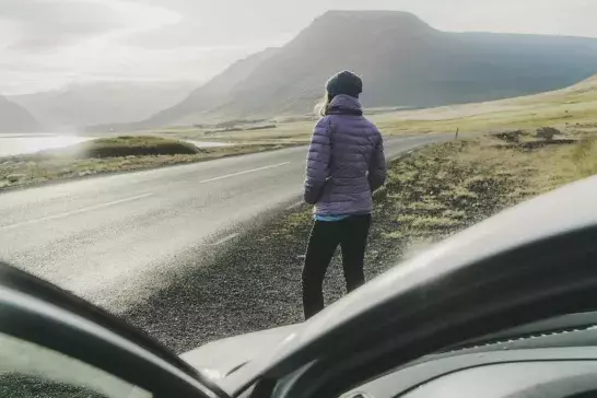 Women standing outside of rental car in Iceland