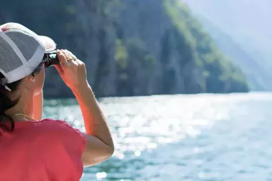 Women on cruise using binoculars