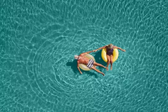 Senior couple floating in the water