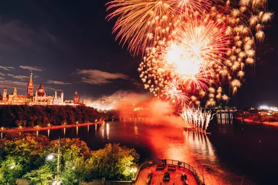 Canadian Parliament on Ottawa River with fireworks