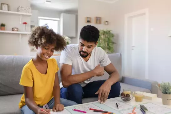 father and child doing crafts