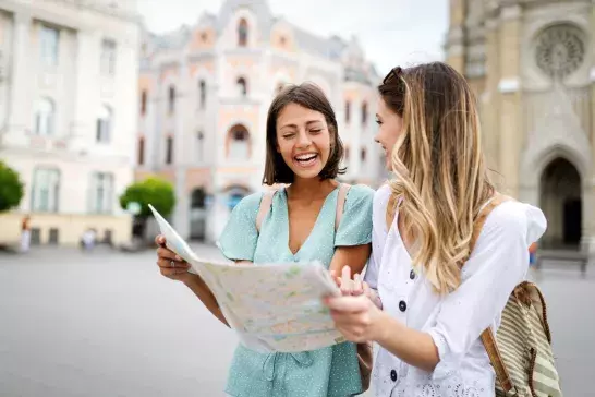 Happy friends enjoying sightseeing tour in the city.