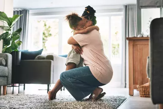 mother and child hugging at home