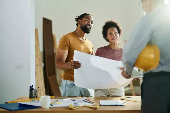 couple talking to real estate agent in the apartment.