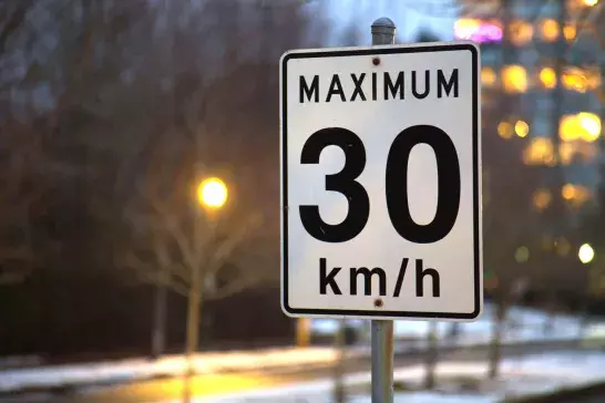 Maximum 30 km/h sign during winter night