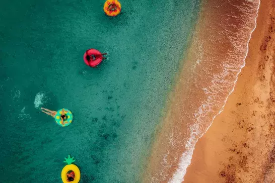 friends having fun on floaties in water