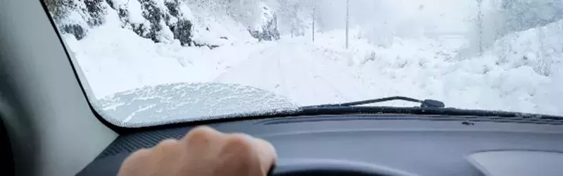 Driving a car on a road full of snow