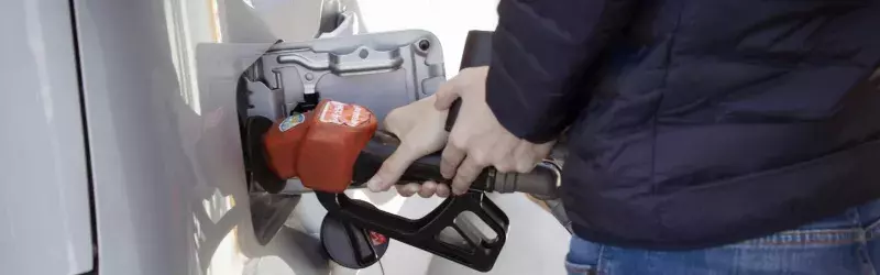 Person pumping fuel into their vehicle