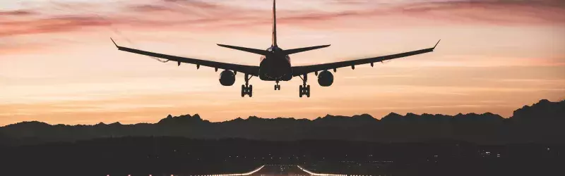 Airplane landing in sunset