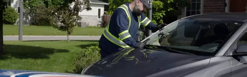 CAA technician at a Member's home fixing a windshield chip 