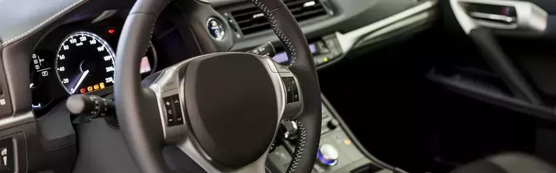 Leather interior of a vehicle with the lights and radio running.