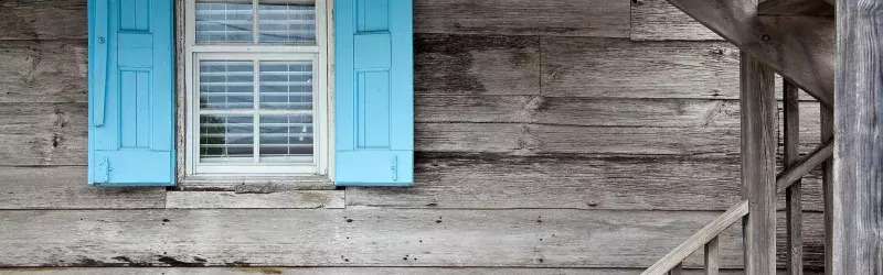 Side of house with blue shutters