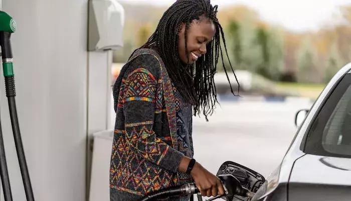 women fueling vehicle