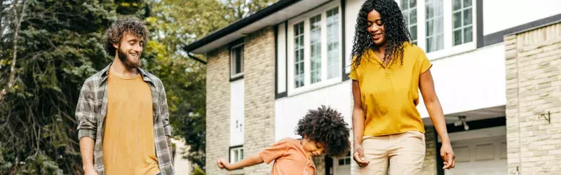 A family playing together in their front yard.