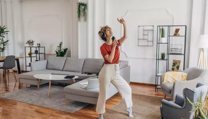 Woman listening to music in apartment