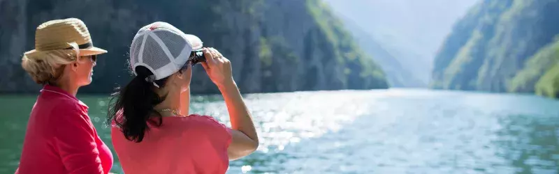 Women on cruise using binoculars