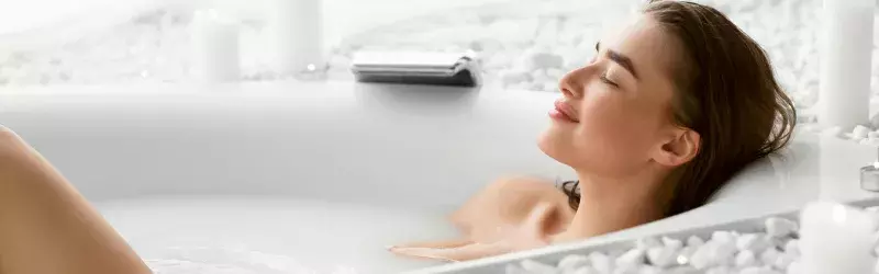 Woman relaxing in bathtub