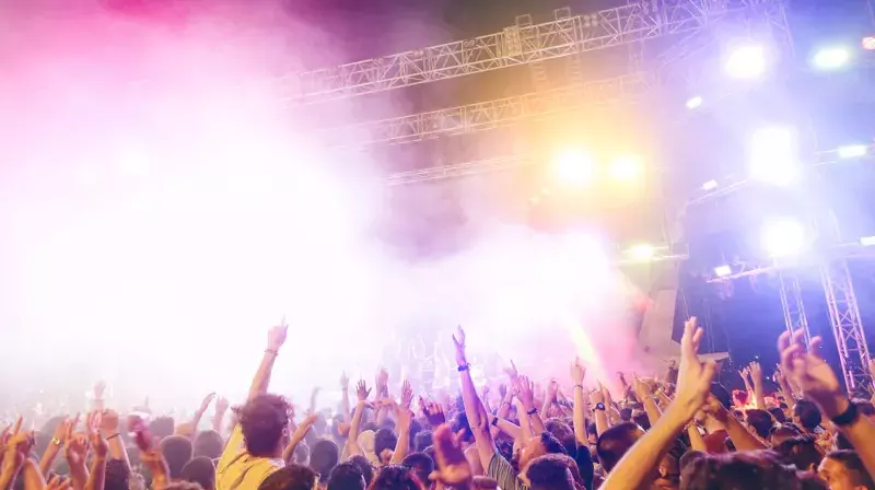 Young people dancing and having fun in summer festival party out