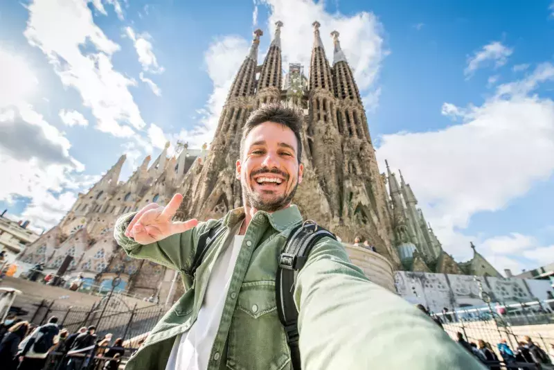 Happy tourist visiting La Sagrada Familia, Barcelona Spain - Smi