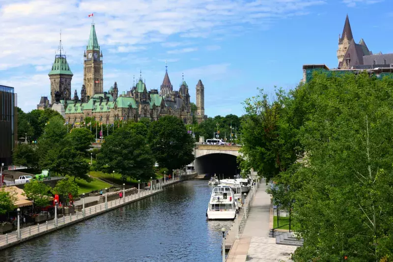 Boat lined Rideau Canal towards Parliament Hill, Ottawa, Ontario, Canada