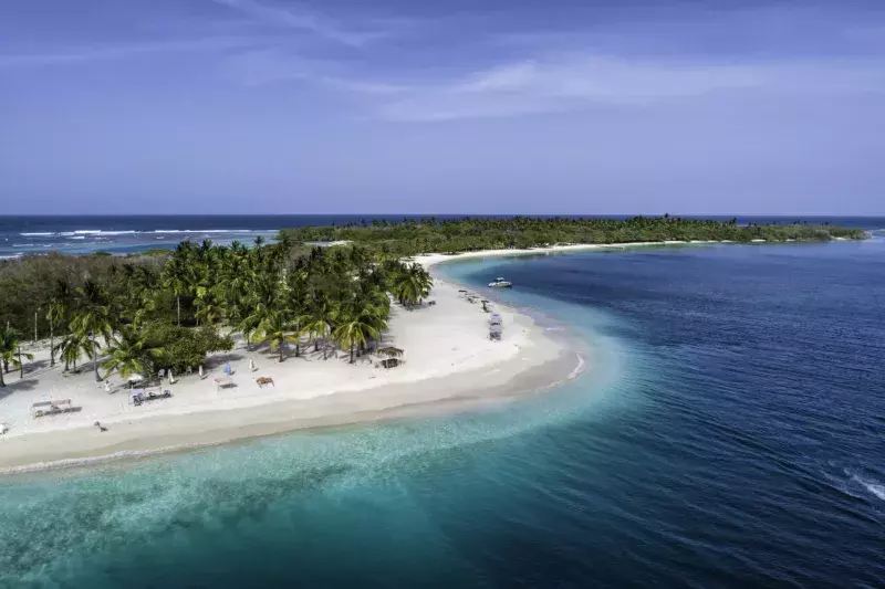 Aerial view of a white sand cay in the Caribbean sea with turquoise waters