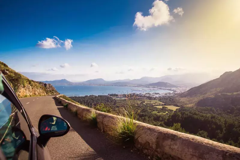 View from car at beautiful summer vacation landscape.. Port, sea, mountains.