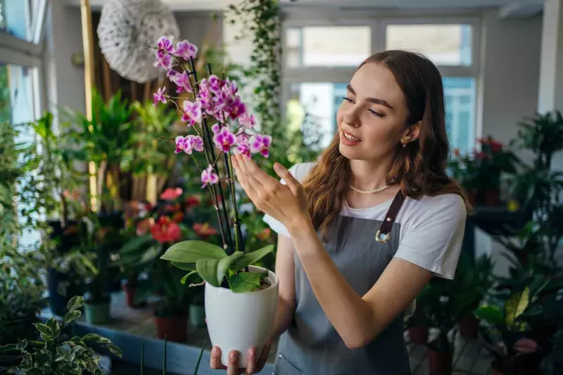 Female florist examining flowers