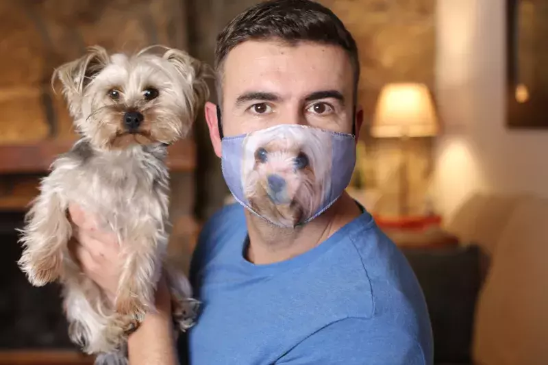 Man wearing protective mask with print of his dog´s face